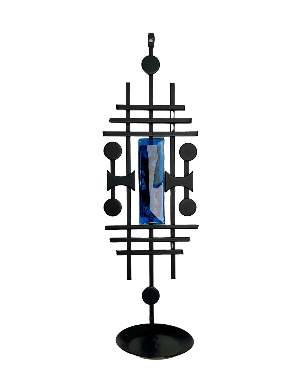 Black geometric decorative object with a blue centre on a white. Dantoft Danish Mid-Century Brutalist Candle Holder. Black Iron & Blue Glass, 1960s.background